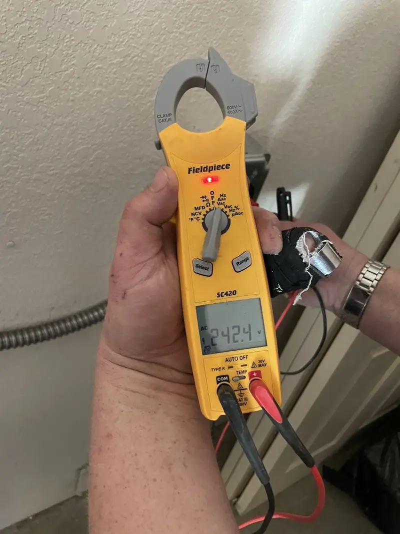 Voltage testing with clamp meter during Recessed Lighting Installation in Webster
